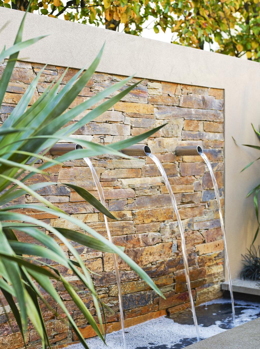 The fountain wall at the rear of the garden, clad in Badger Dry Stone walling from Eco Outdoor, is more than just a handy trick to hide the pool equipment.
