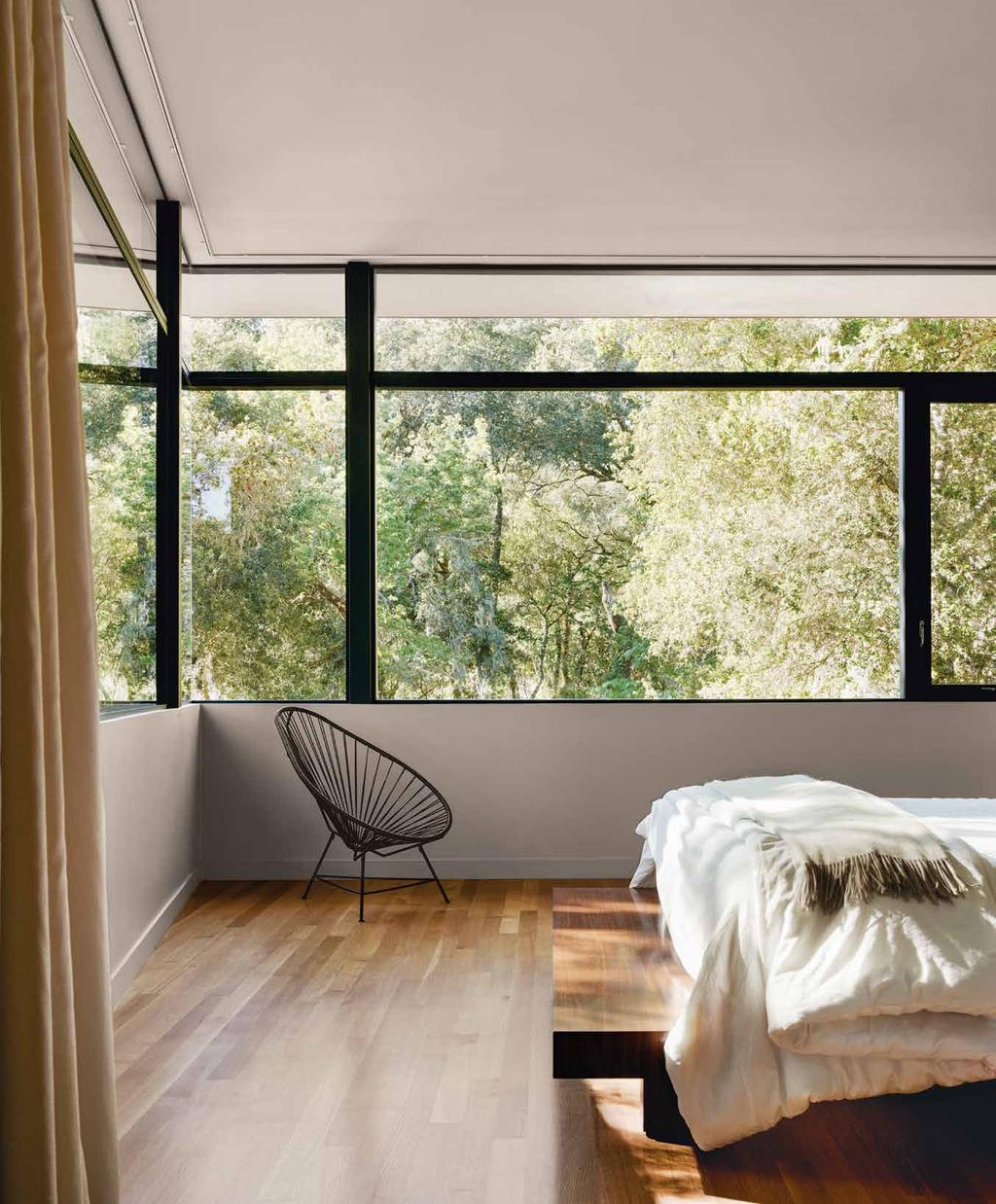 Left: A floor-to-ceiling window allows natural daylight into the guest-wing bathroom.
