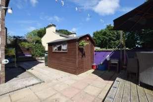 To the rear and side of the property is an easy to maintain patio with raised decking area complemented by a variety of flowers and shrubs. Garden shed.