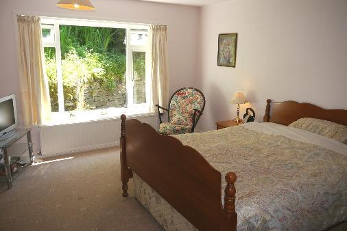 Very spacious and attractive dual aspect room with a feature picture window with attractive views over the garden towards Silver Howe and surrounding country side.