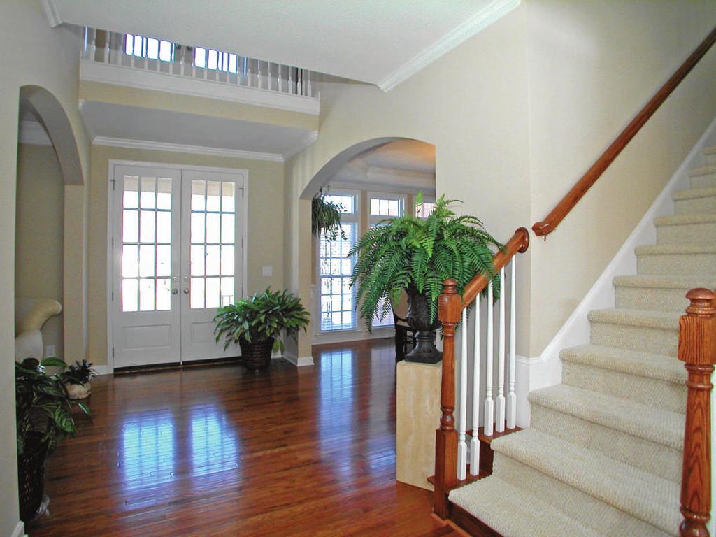 Classic and elegant center hall style foyer provides a beautiful introduction to the home, complimented by: Gleaming hardwood floors Double-height