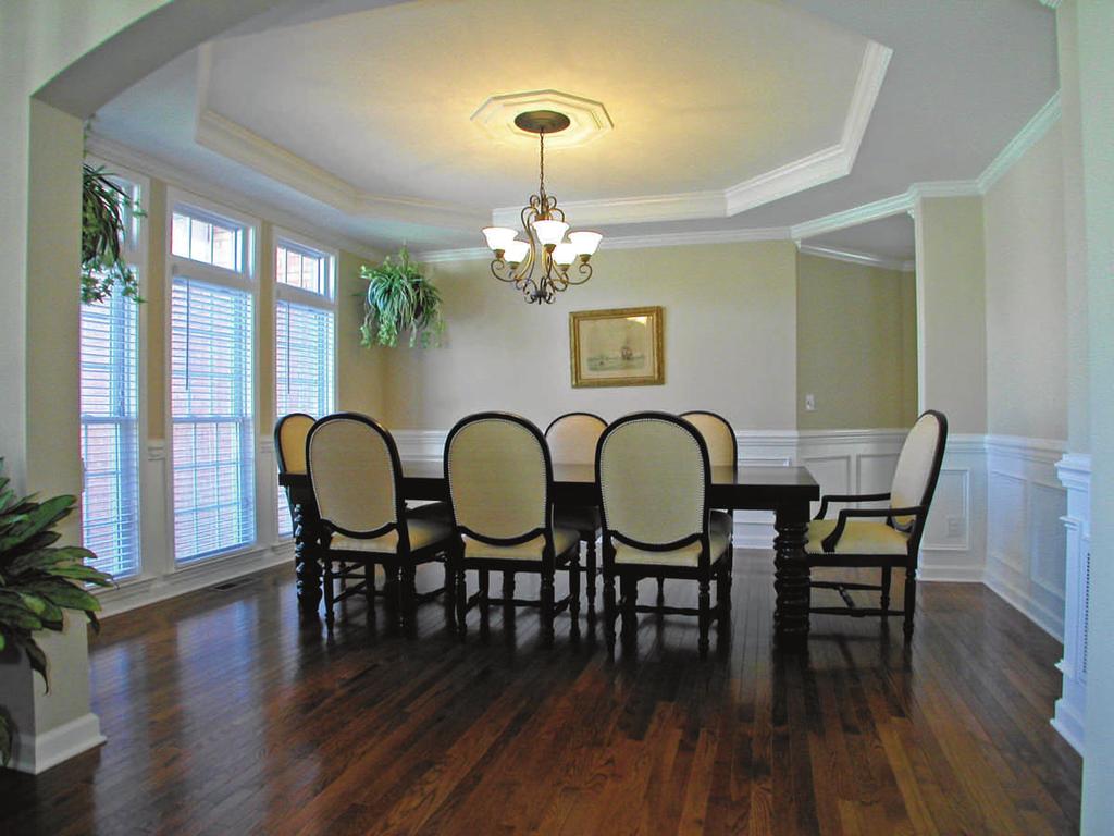 the oversized formal dining room to the left of the foyer, highlighted by: Gleaming hardwood floors Triple, French-style windows with transom window