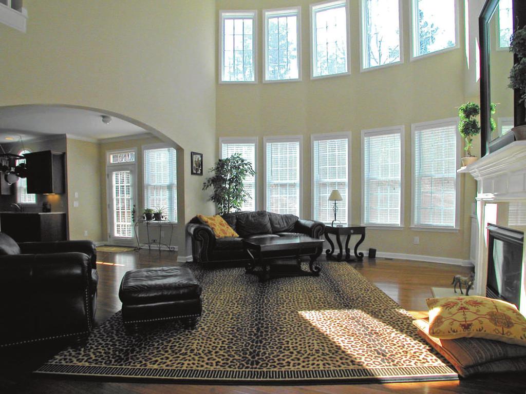 The dramatic and spacious 2-story great room is open to the kitchen and breakfast