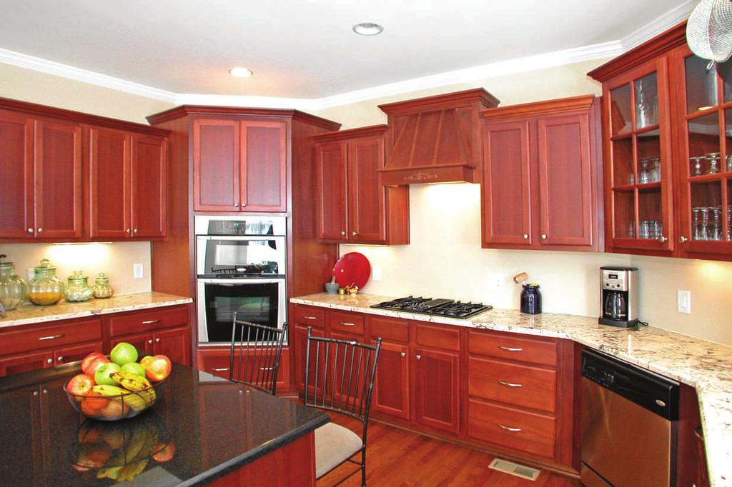 Crown molding Kitchen is equipped with: Gas cook top with down draft & decorative hood Stainless steel dishwasher Stainless steel wall oven
