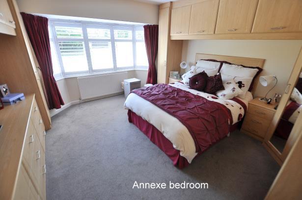 The annexe bathroom/shower room has been refitted in a stylish white suite and incorporates a panelled bath with mixer taps and shower hose, wash hand basin with vanity storage beneath, separate