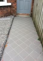 grey tile path to the front door.