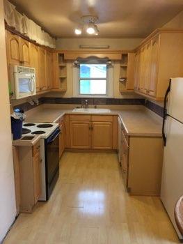 1. Kitchen Room Kitchen Walls and ceilings appear in good condition overall. Flooring is laminate. Heat register present. Accessible outlets operate. Light fixture operates.