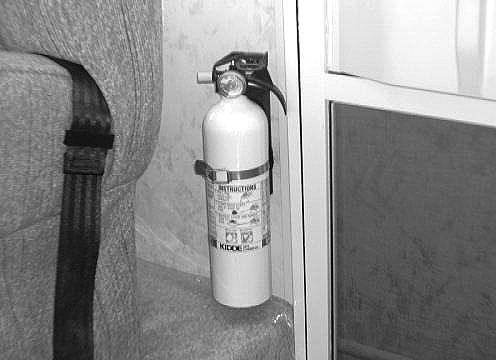 FIRE EXTINGUISHER A dry chemical fire extinguisher is located near the main entrance door.