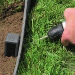 Use a rubber hammer to pound the Ecopic stakes into the ground.