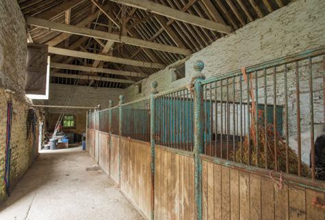 impressive vaulted ceiling with exposed beams has 5 interior stables The two main barns are connected by the tack room with Belfast sink and open