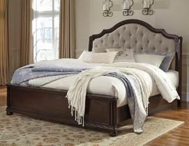 American style with updated detailing Made with select Mindi veneers and hardwood solids in a brown cherry finish Bed features lay-back style upholstered headboard with deep button tufting
