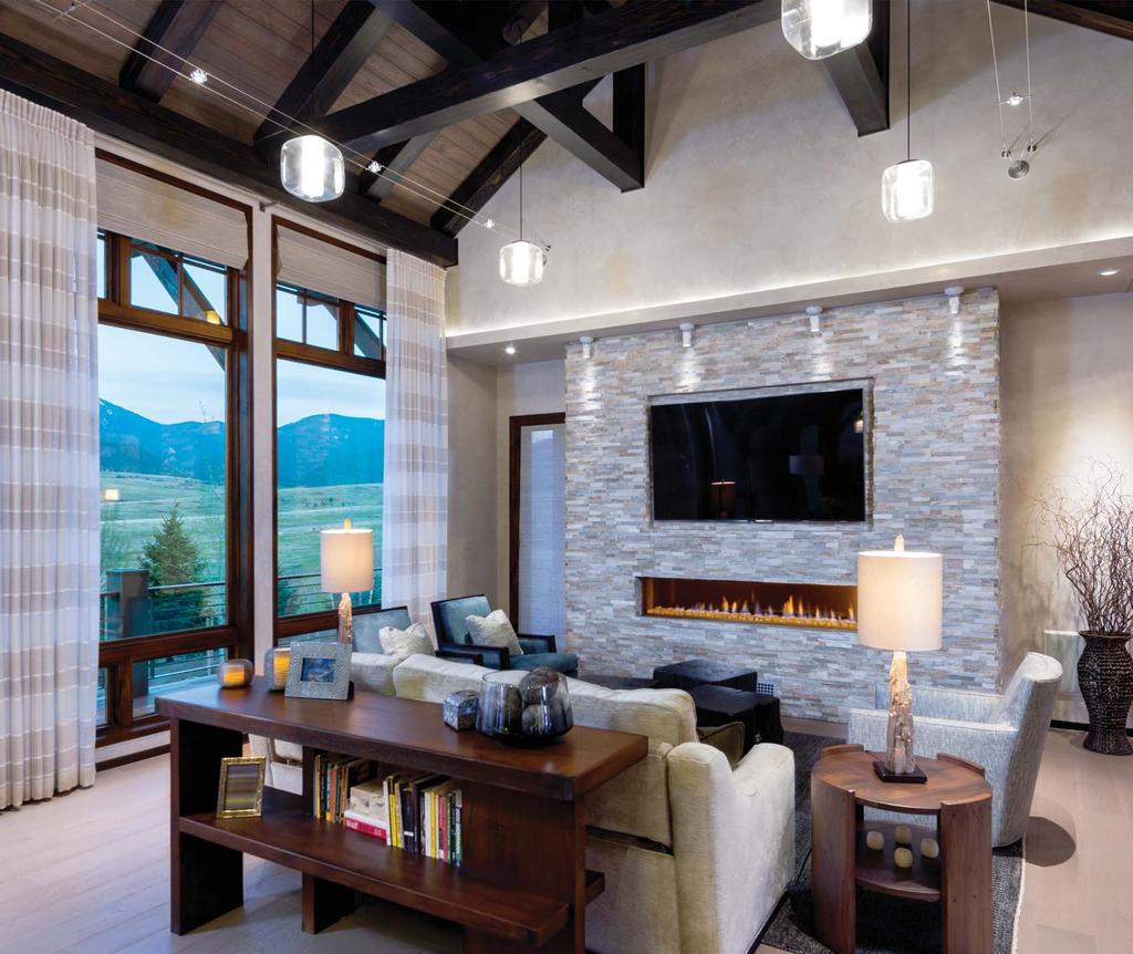 LEFT: THE SLEEK GAS FIREPLACE AND BUILT-IN TV ON A WARM-TONED STONE WALL BRING CONTEMPORARY FLAIR TO A CLASSIC TIMBER FRAME.