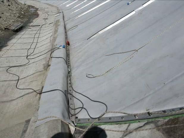 tensioning of the sheets (figure 9). Geocomposite strips were then welded over the upper Ω- shaped profile (figure 10).