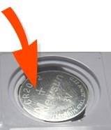 edge of the battery is inserted first against the contact: Use a coin to turn