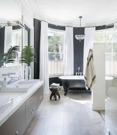 From top, light floods the master suite, complemented by a private, verdant balcony; a custom-painted, claw-foot Kallista tub brings a vintage note to the luxurious modern master bathroom.