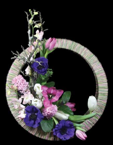MODIFIED L SHAPE LINE Pear wood branches were placed first in a vertical position followed by Tulips, Dendrobium Orchids and Anemones.