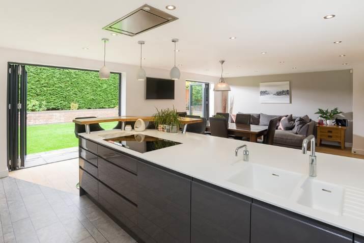 KITCHEN/DINER a stylish open plan living/dining space with two sets of bi-folding Schuco doors onto the garden.