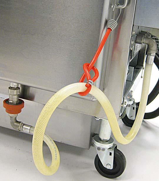 2.5 Installing the Oil Saddle Reservoir (Applicable to fryers with side oil saddle reservoir only) Carefully cut the shipping strap around the oil saddle hose on the rear of the fryer.
