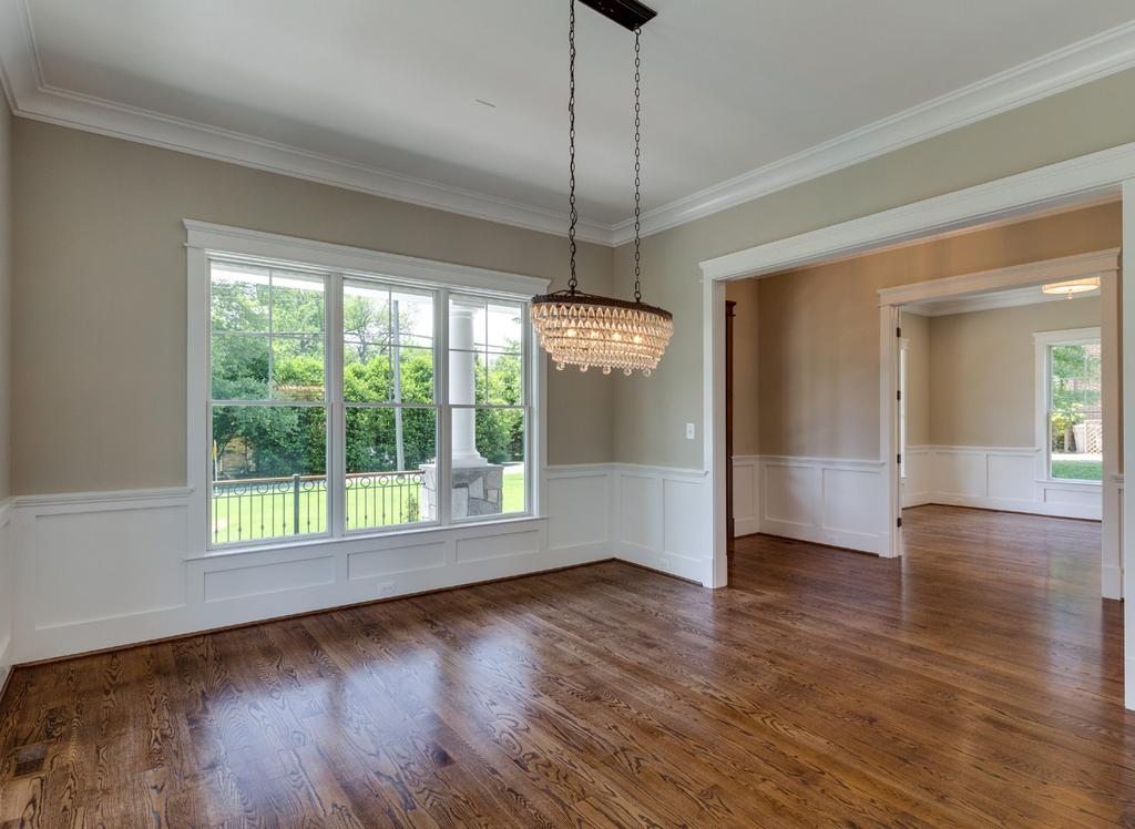 Other exceptional details include shining hardwoods floors thr oughout the main level, decorative moldings, cof fer ed ceiling & custom tile work, gour met eat-in kitchen with lar ge