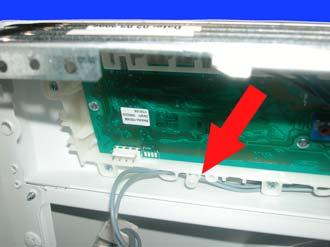 Remove the screw which secures the control panel to the
