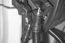 The drain hose is plugged by placing the hose plug in the end of the hose and turning the plug latch to tighten the plug.