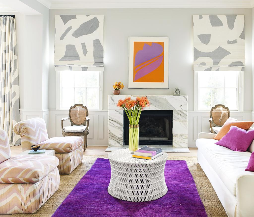Hranowsky brightened the living room s dark wood moldings by painting them in Farrow & Ball s Skimming Stone. A Jack Youngerman silk-screen adds a pop of orange and purple.