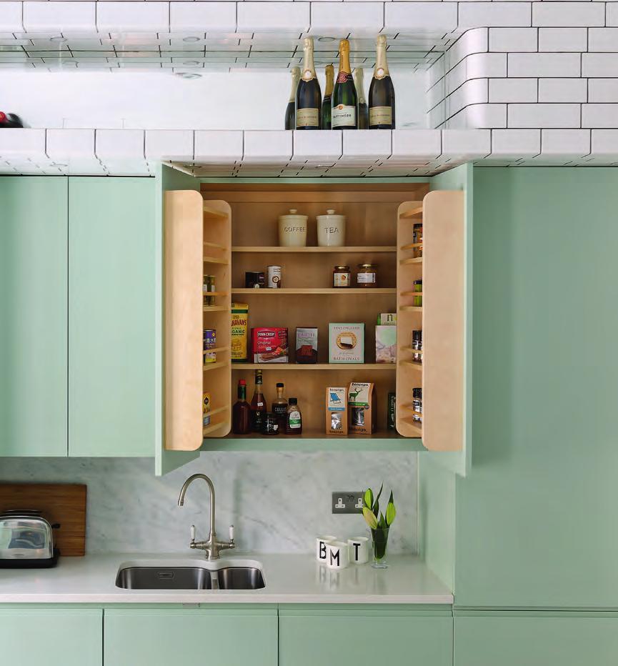 ON THE RACK Left Birch-lined cupboards include racks for tea, coffee, condiments and spices ZONE IT Below left The sleek Miele oven is built into the island, just below the hob, so that cooking