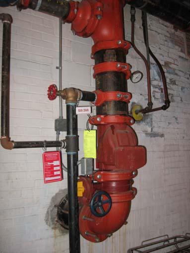 Sprinkler System The cafeteria area is served by an automatic sprinkler system. There is one riser located in the boiler room. Design data was listed on the valve as 413 GPM at 61.6 psi.