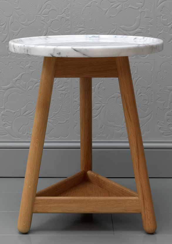 CARVE A generous marble-topped table with a carved rim on a solid wood base with turned legs.