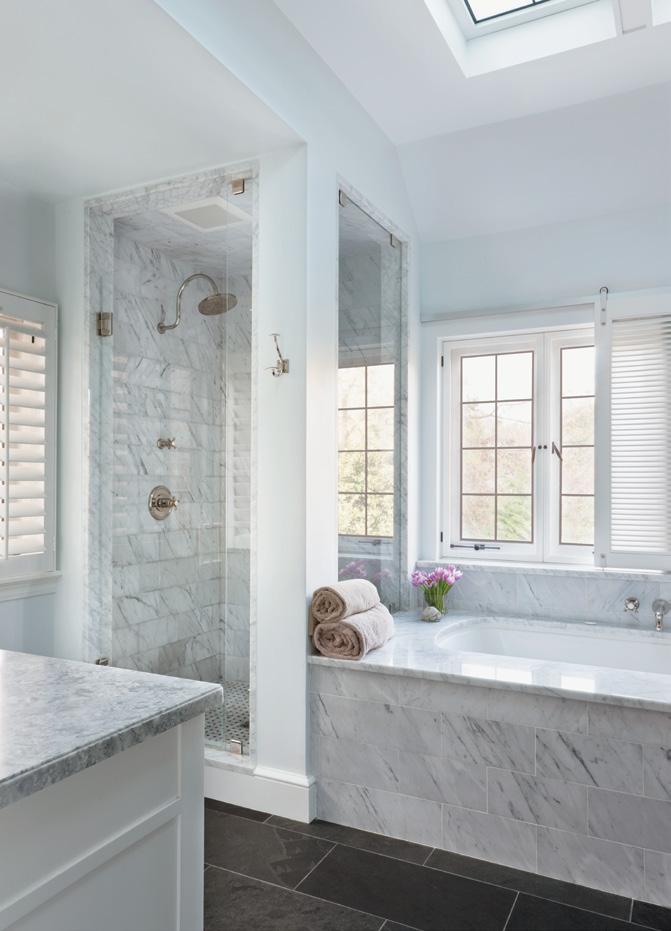 The owners wanted their master bathroom to be a quiet, soothing space, Welch says. She responded with dark slate floors and Carrara marble from Architectural Ceramics.