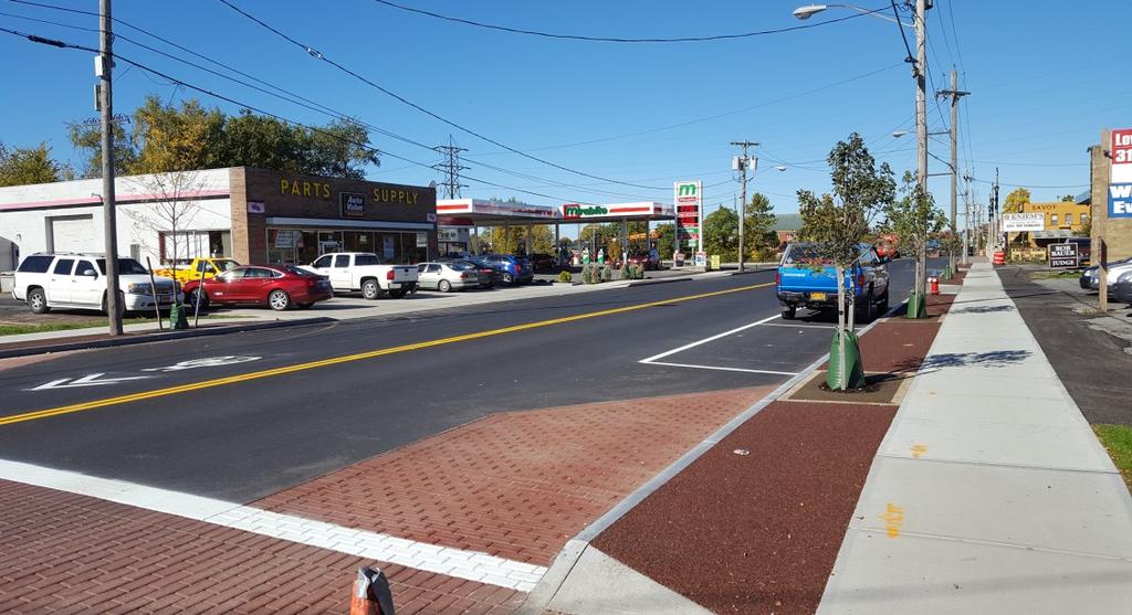 On-street parking is prevalent along the East Dominick Street corridor, which provides a buffer to sidewalk areas while providing service to area businesses.