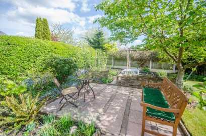 REAR GARDEN To the rear there is an extensive block paved patio area, lawned garden with