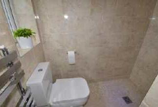 c and continental type shower with mains pressure shower head and drench head. Fully tiled walls and flooring.