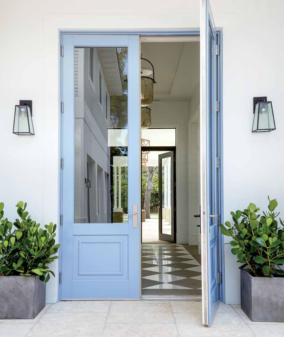The custom-painted entry doors from Ultimate Door are visible only from the home s inner courtyard.