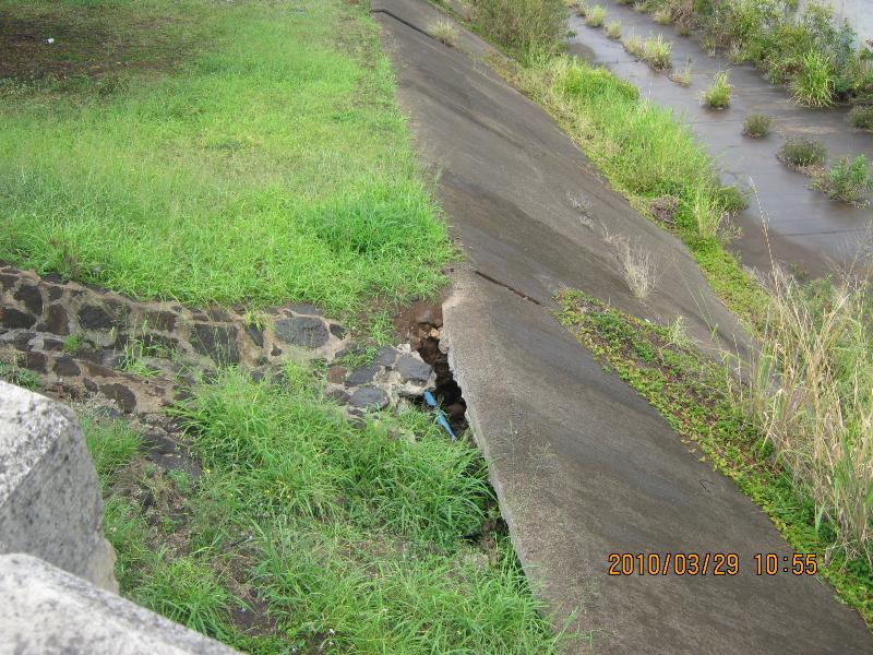 A gap has formed between the end of the spillway and the stream bank allowing storm water to erode sediment from the area behind the concrete stream channel liner.