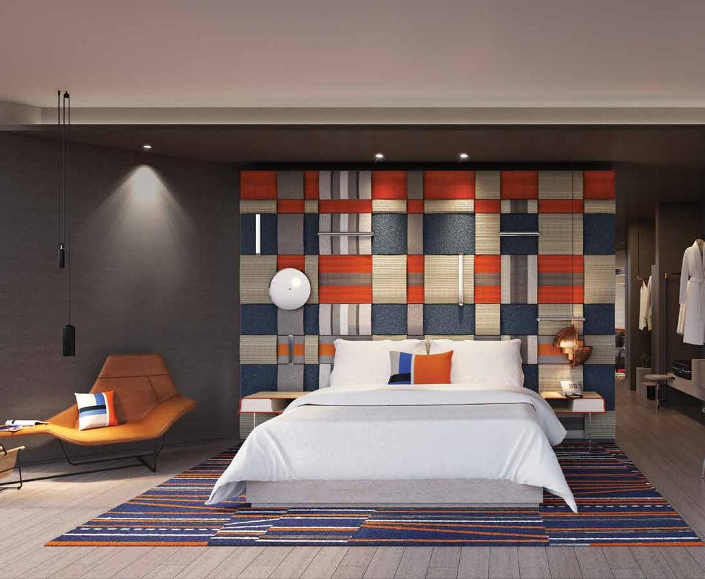 REGIONAL INTERIORS Bold blue and orange colours in the custom headboard artwork depict luxury watchbands woven together Another challenge was the architecture itself the building was a mixed-use