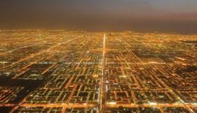 Figure 1. An aerial night shot demonstrates the regularity of the Riyadh street grid. Figure 2. A typical Riyadh street view reveals the dominance of cars over the built environment.