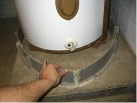 When the pan terminates to the exterior of the dwelling, it should terminate at least 6 inches, and, at most, 24 inches, above the adjacent ground surface.
