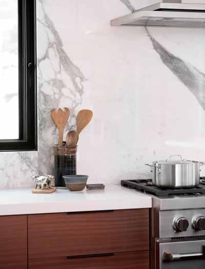 The Sub-Zero fridge is also behind the veneer while the Jenn-Air oven and microwave are tucked out of view The antique brown leathered granite has a nice matte finish and