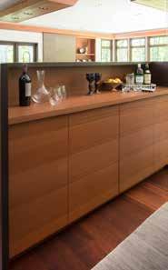 The island s sapele base was stained dark brown to anchor the unit and to echo the dark granite.
