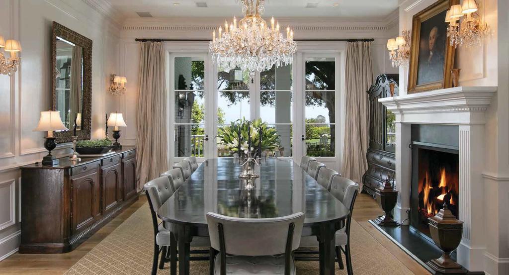 FORMAL DINING ROOM An exercise in elegant formality, the inviting dining room is accented by extensive custom crown molding, wainscoting, and a