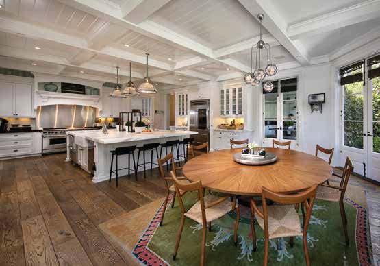 The space which includes a welcoming breakfast nook is replete with traditional wood and