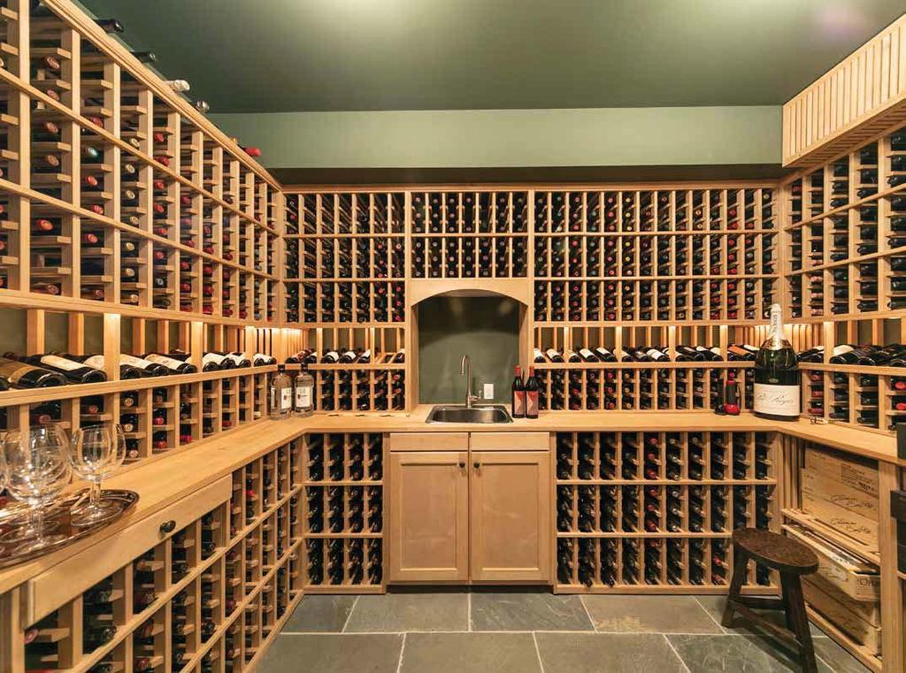 LOWER LEVEL The handsome cedar-walled wine cellar has a capacity of 1,800 bottles, counter space, and a handy