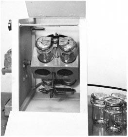 FIG. 1 Washing Machine, Heated Air Bath (Procedure B) specimen containers so that they are relative to the axis of the motor shaft in the same way as in the Launder-Ometer, can be used.