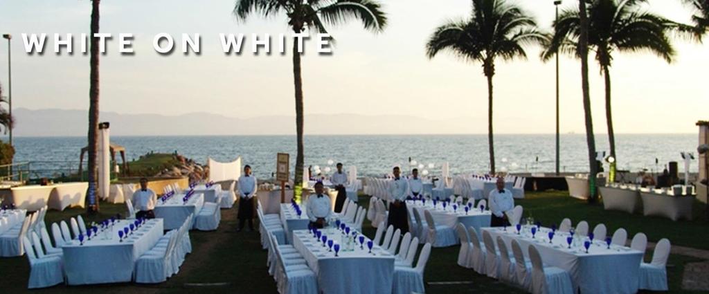 Center Piece White tablecloth, White napkin Blue wine glass Illuminated rectangular tables White