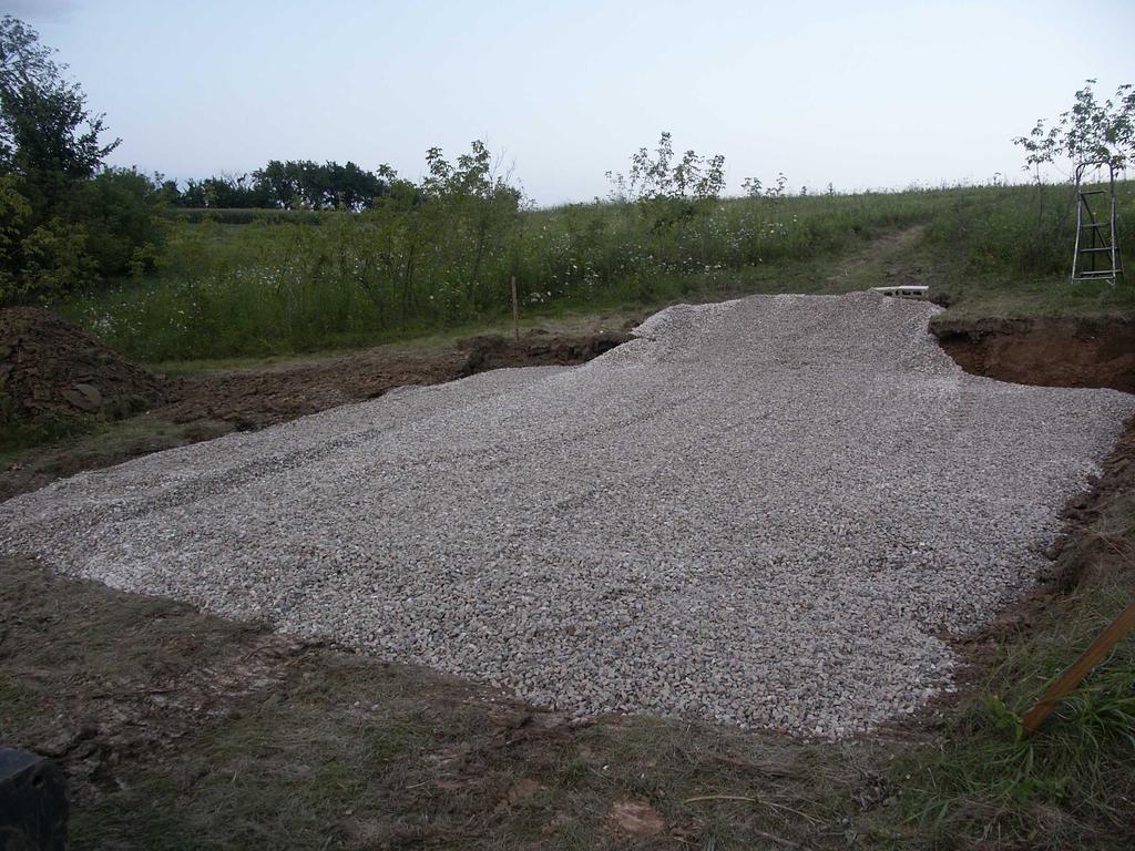 This shows the site after leveling with a borrowed Bobcat and spreading a few inches of washed,