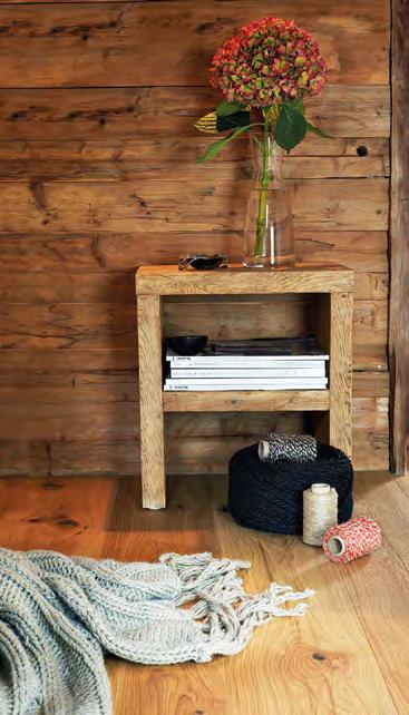 A bulky workbench is skilfully turned into a stage for still life, rustic planks serve as a writing desk in