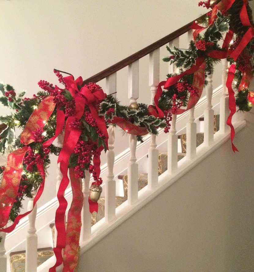 It is simple to achieve graceful results using permanent (artificial) botanical greenery, berries, and ribbon when decorating a staircase.