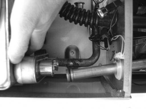 Unscrew the three bolts M from the main heat exchanger (Fig.