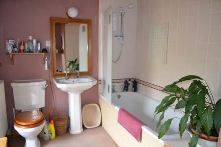 En suite: Large bathroom housing three piece suite comprising panel bath with